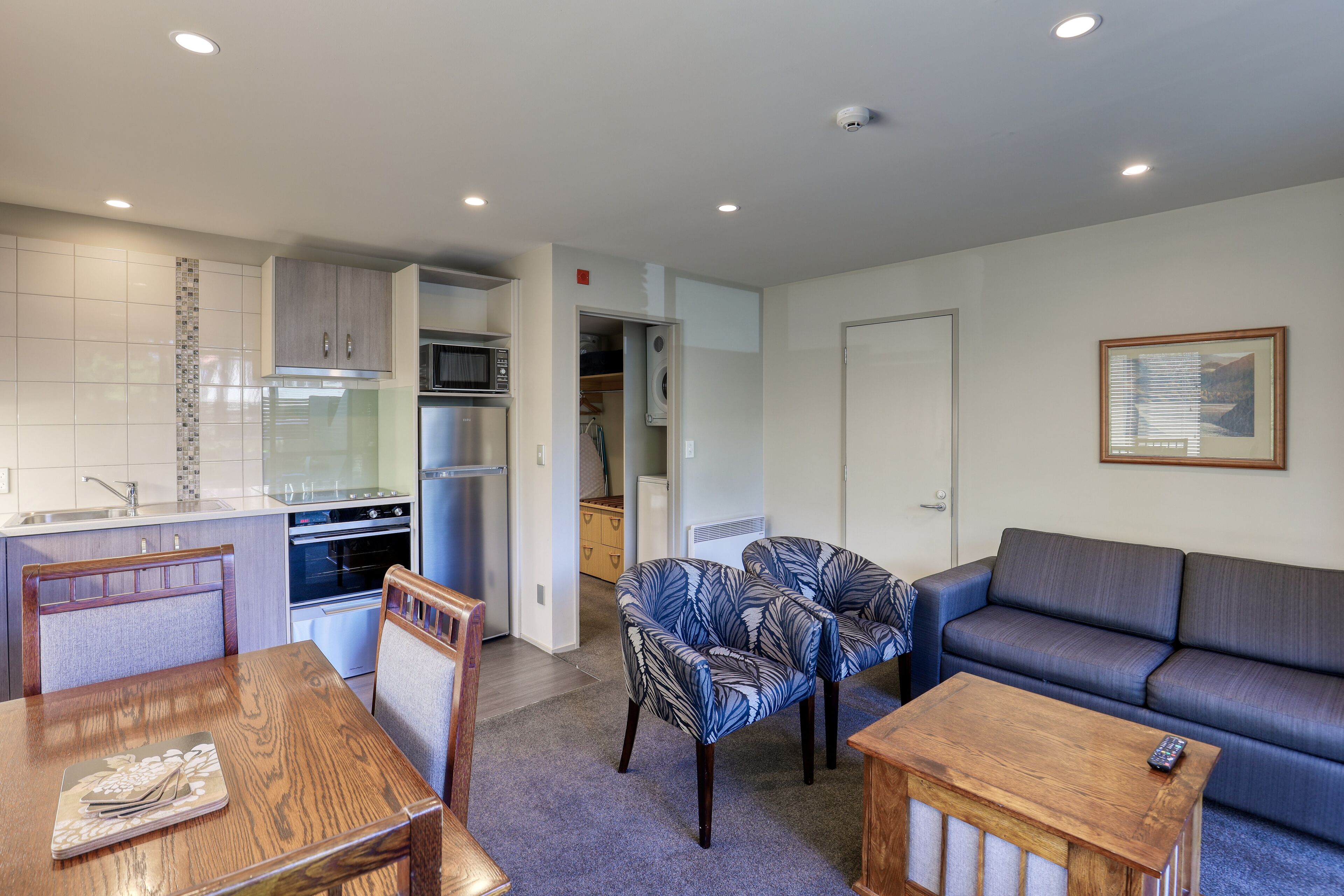 A compact living space with a kitchenette, dining area, and seating area.