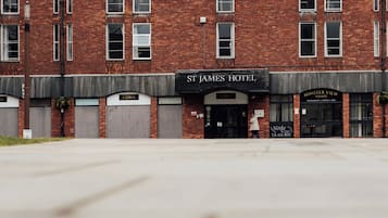 En murstensbygning med flere butikker, herunder 'St. James Hotel' og 'Minster View'.