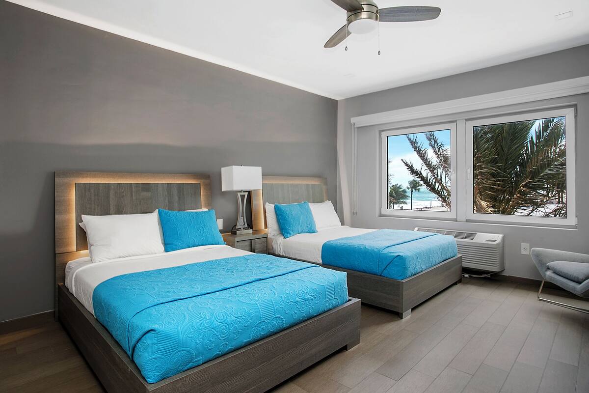Partial Ocean View Room with Two Double Beds | Premium bedding, in-room safe, desk, blackout drapes