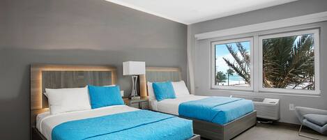 A modern hotel room with two beds, a ceiling fan, and a large window with a view of palm trees.