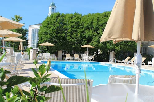 Seasonal outdoor pool, open 9:00 AM to 10:00 PM, pool umbrellas