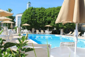 Seasonal outdoor pool, open 9:00 AM to 10:00 PM, pool umbrellas