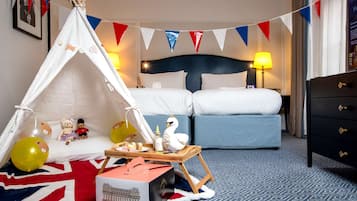 Relax in a cozy retreat with a comfortable bed, bedside table, and decorative tent.