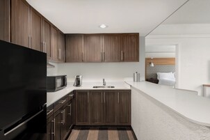 Hypo-allergenic bedding, desk, laptop workspace, blackout drapes