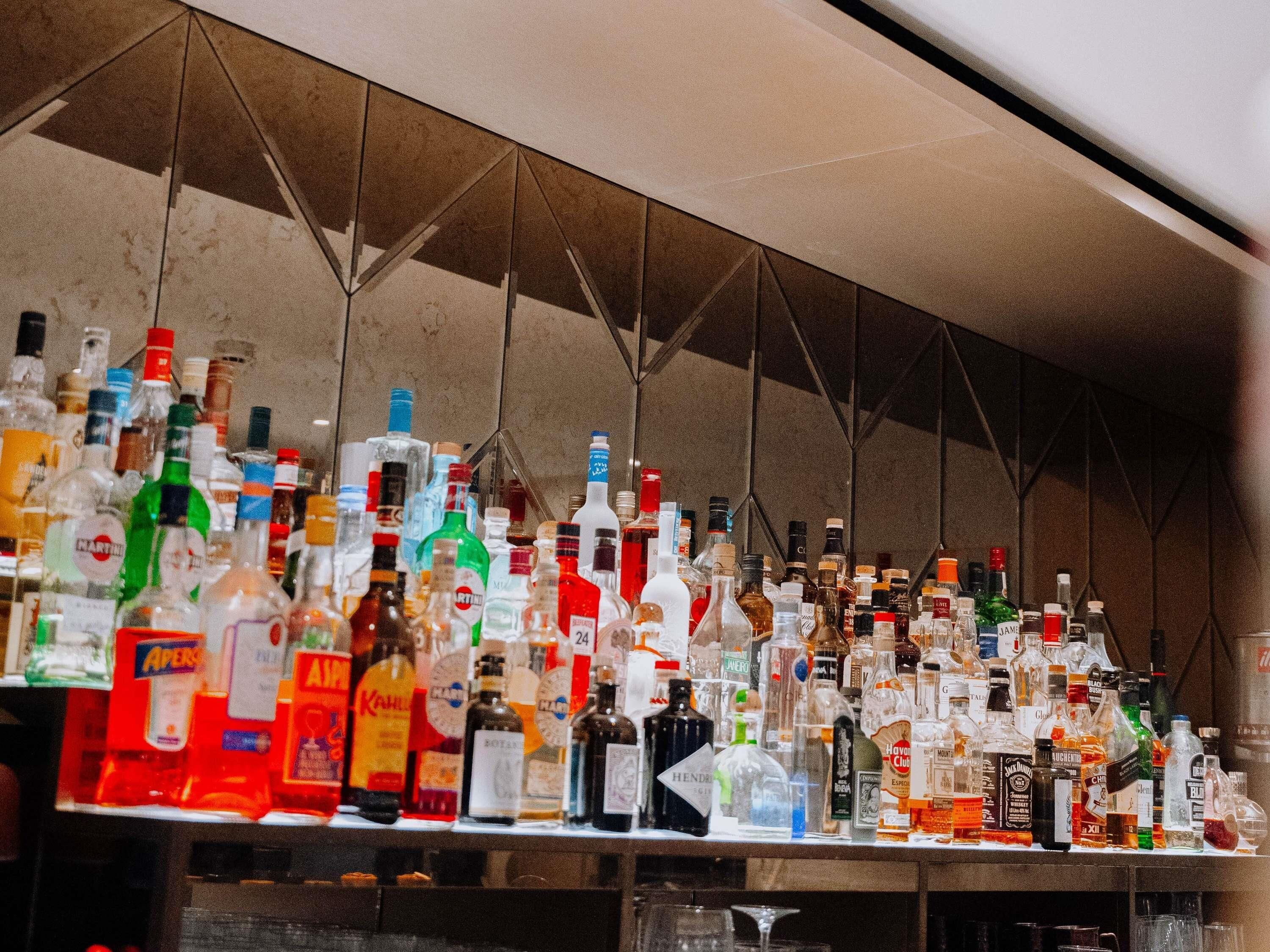 A bar with a variety of liquor bottles.