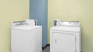 Two white front-loading washing machines in a room with light yellow and blue walls. - Days Inn by Wyndham Morristown (Morristown)