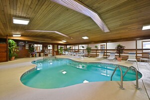 Una piscina techada, sillones reclinables de piscina