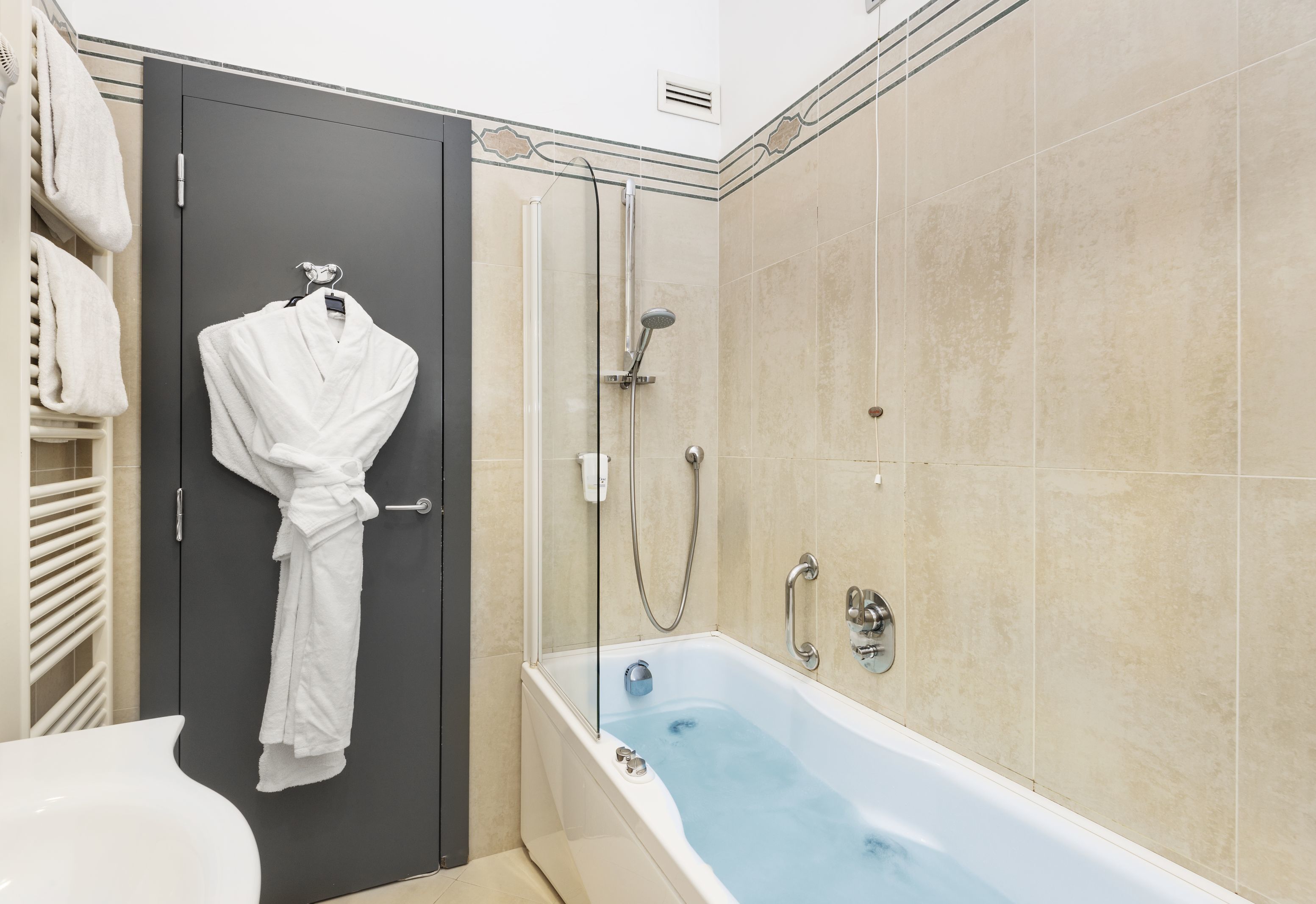 junior suite, 1 king bed, jetted tub | bathroom | eco-friendly toiletries, hair dryer, towels