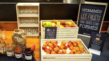A display of seasonal fruits, jars of preserves, and a sign promoting the health benefits of fruits.