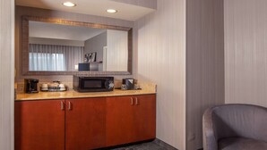 A hotel bathroom with a large mirror, a microwave, and a coffee maker on the countertop. - Sonesta Select Newark Christiana Mall (Newark)