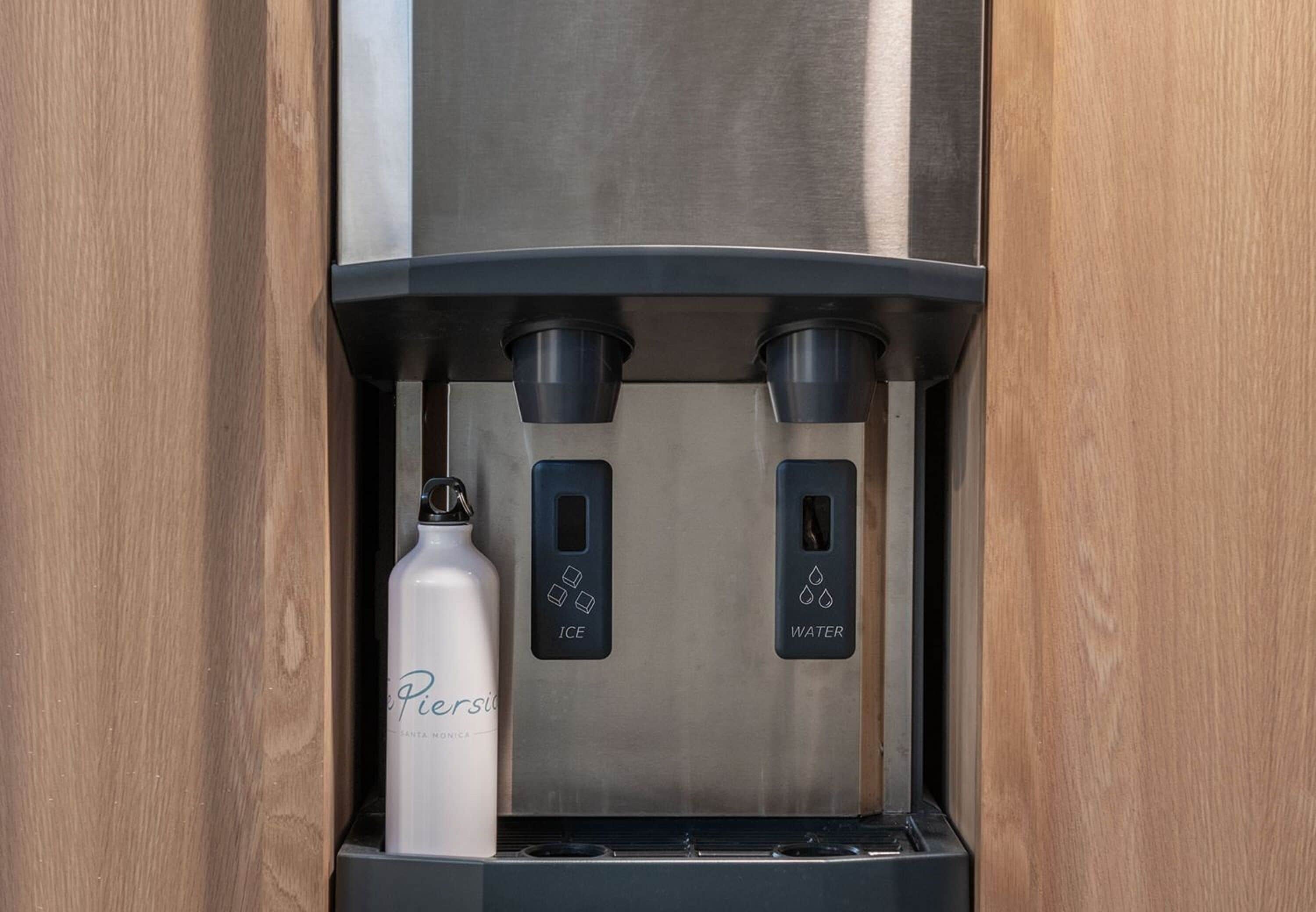 A water dispenser with two spouts, one for ice and one for water, and a bottle labeled "Pier's."