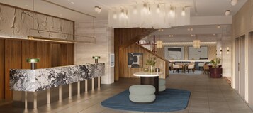 A modern lobby with a marble reception desk, a staircase, and a dining area with chairs and tables.