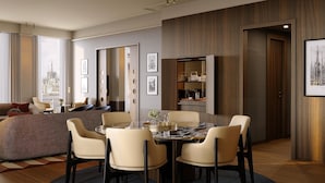 A modern hotel room with a dining area, a sofa, and a view of a cityscape.