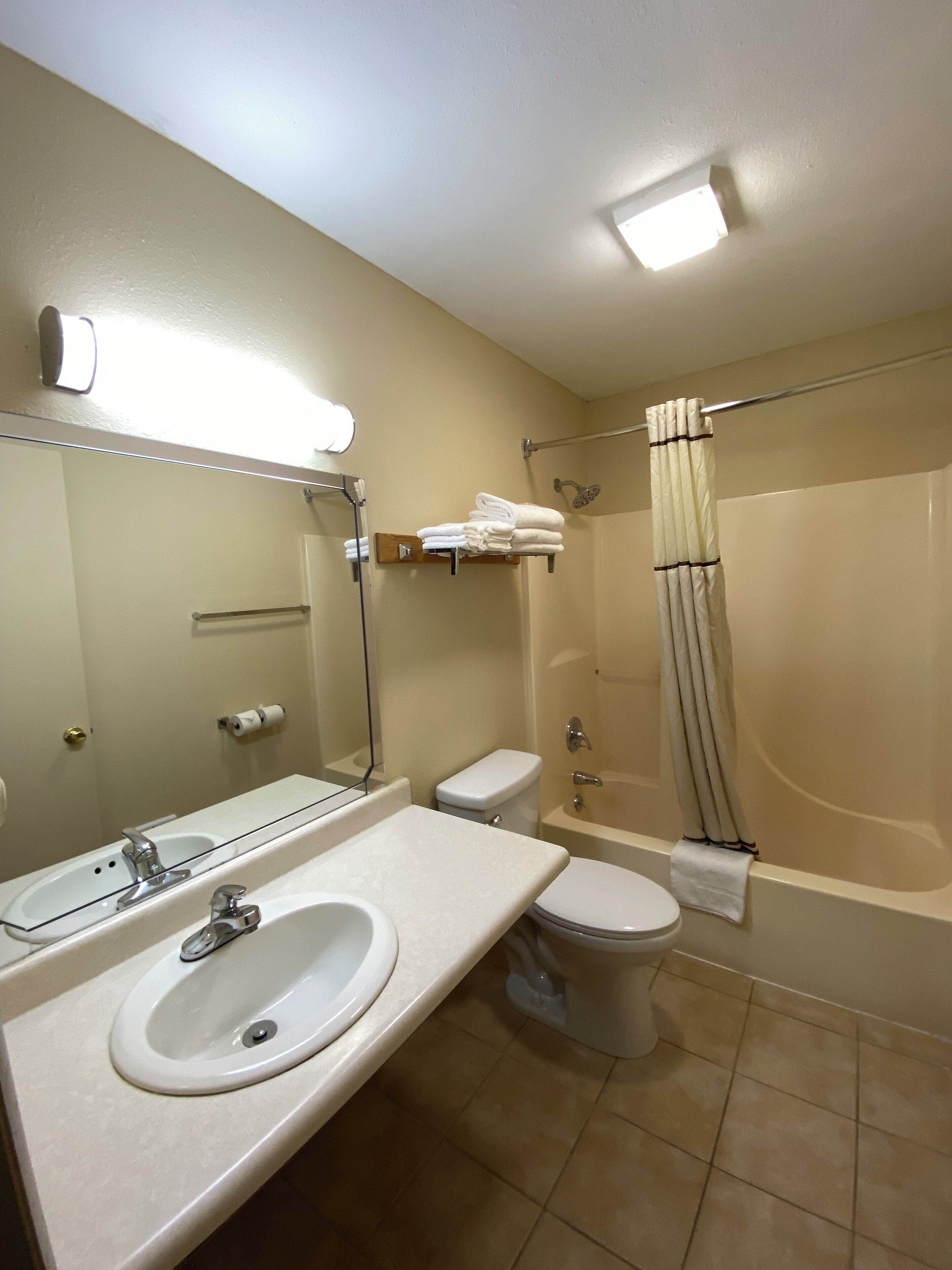 A bathroom with a sink, toilet, and bathtub.