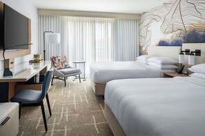 A hotel room with two beds, a desk with a chair, a TV, and a large window with curtains. - Tampa Airport Marriott (Tampa)