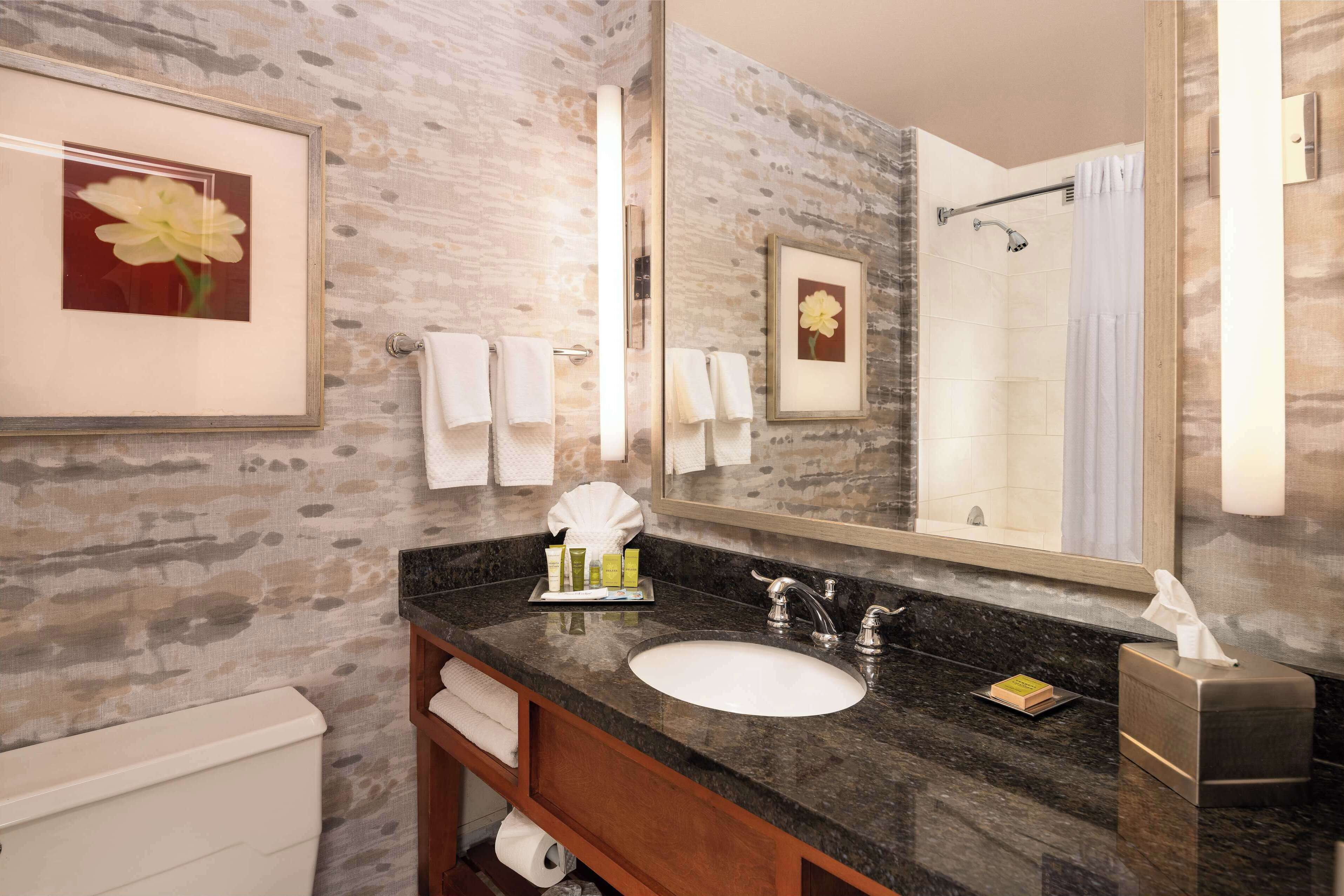 designer toiletries, hair dryer, towels