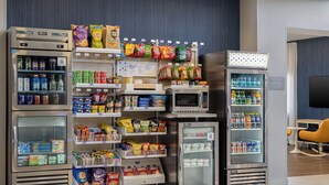 A vending machine area with various snacks, drinks, and microwaves. - Spark by Hilton Toronto Mississauga (Mississauga)