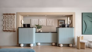 A modern kitchen with two light blue cabinets, a central island with a plant, and a wooden ceiling. - Hotel Avante - JDV by Hyatt (Mountain View)