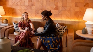 Two people sitting on a sofa in a room with a geometric patterned wall and a round table with a lamp. - Hotel Avante - JDV by Hyatt (Mountain View)