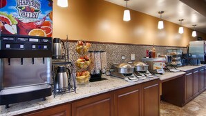 A self-service breakfast station with juice dispensers, a coffee maker, and a variety of food options. - Best Western Executive Inn Kenosha/Pleasant Prairie (Kenosha)