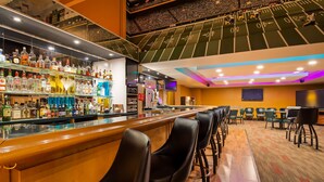 A bar area with a football-themed ceiling and a variety of liquor bottles. - Best Western Executive Inn Kenosha/Pleasant Prairie (Kenosha)