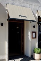 A building entrance with a sign reading "Petra" above the door.