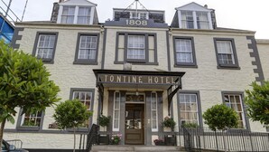 Un bâtiment historique portant l’enseigne « Tontine Hotel » et le numéro « 1808 » au-dessus de l’entrée.