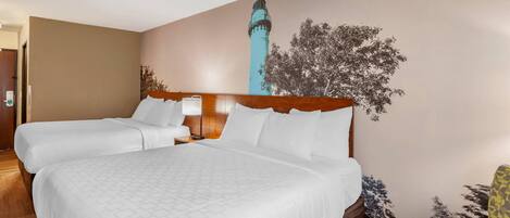 A hotel room with a large bed, a wooden headboard, and a wall mural.