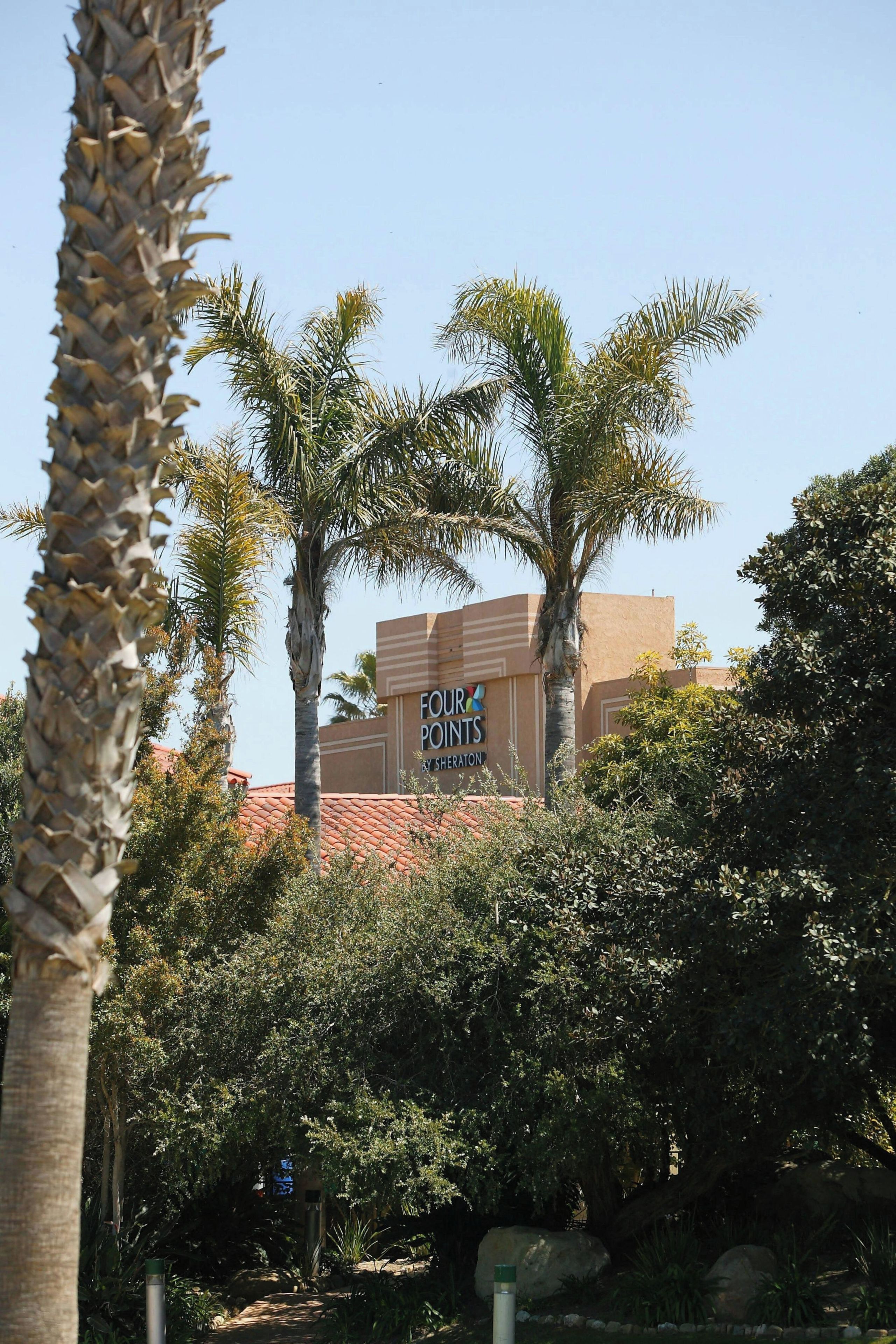 A building with a sign that reads 'FOUR POINTS BY SHERATON.'