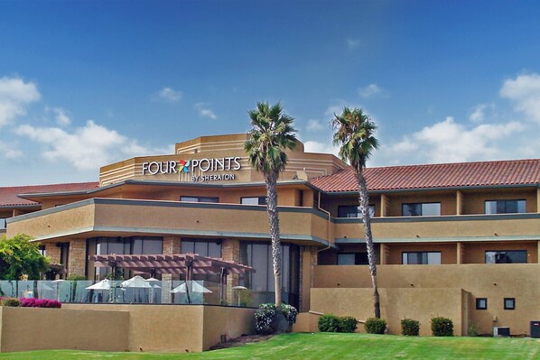 A hotel with a sign reading "FOUR POINTS BY SHERATON" and a covered outdoor area with umbrellas. - Four Points by Sheraton Ventura Harbor Resort (Ventura)
