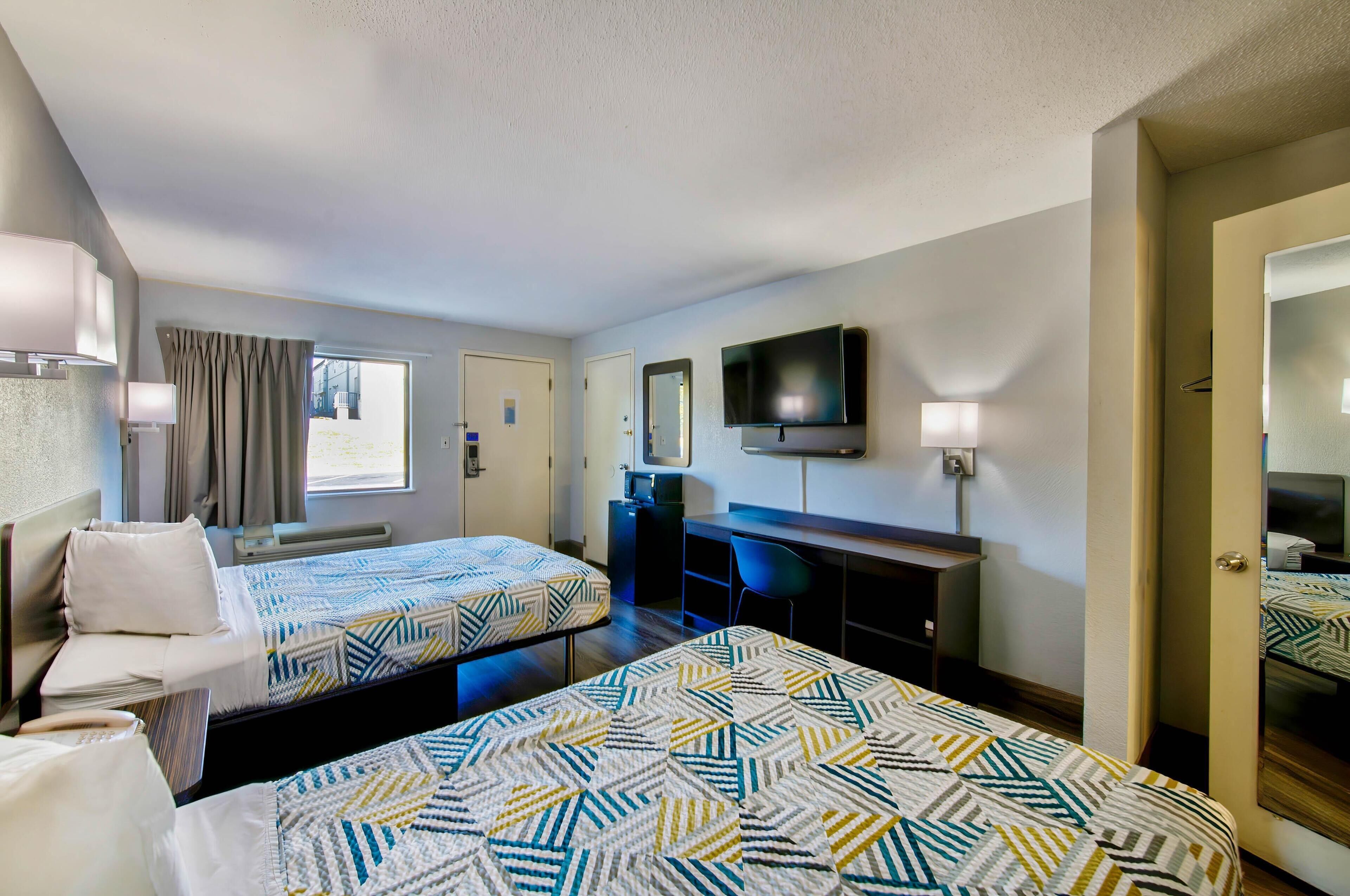 Premium bedding, desk, laptop workspace, rollaway beds