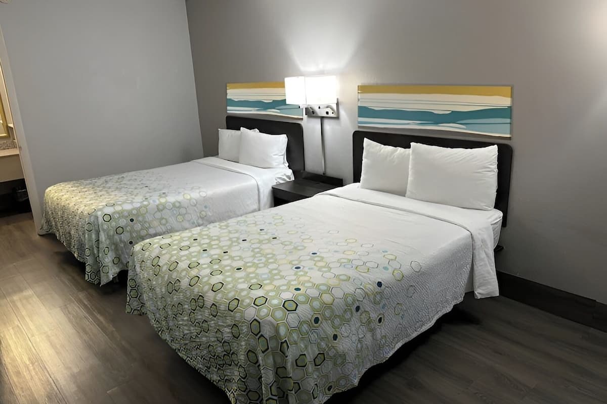Premium bedding, desk, laptop workspace, blackout drapes