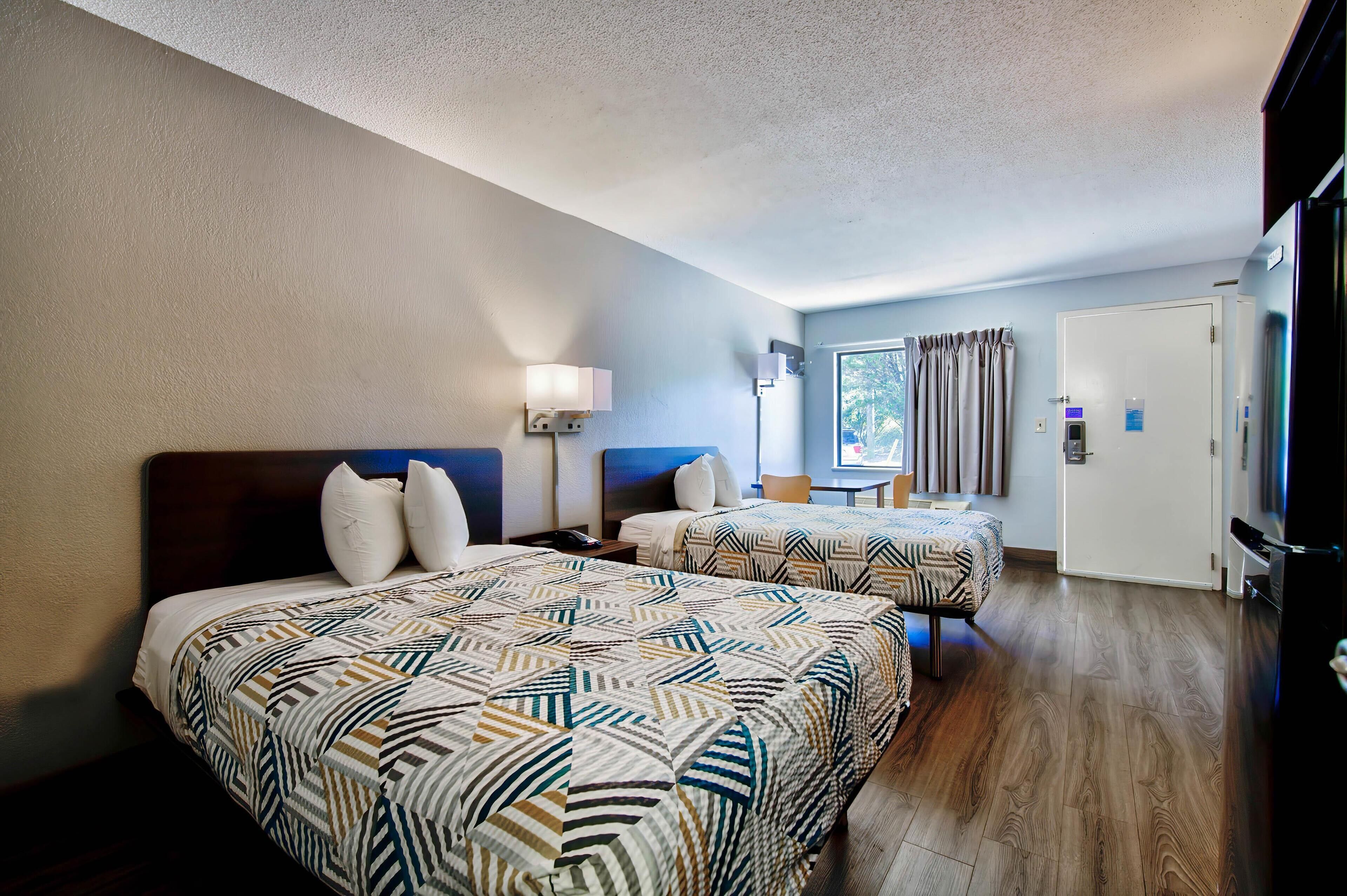 Premium bedding, desk, laptop workspace, rollaway beds