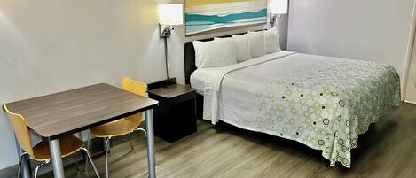 Premium bedding, desk, laptop workspace, blackout drapes