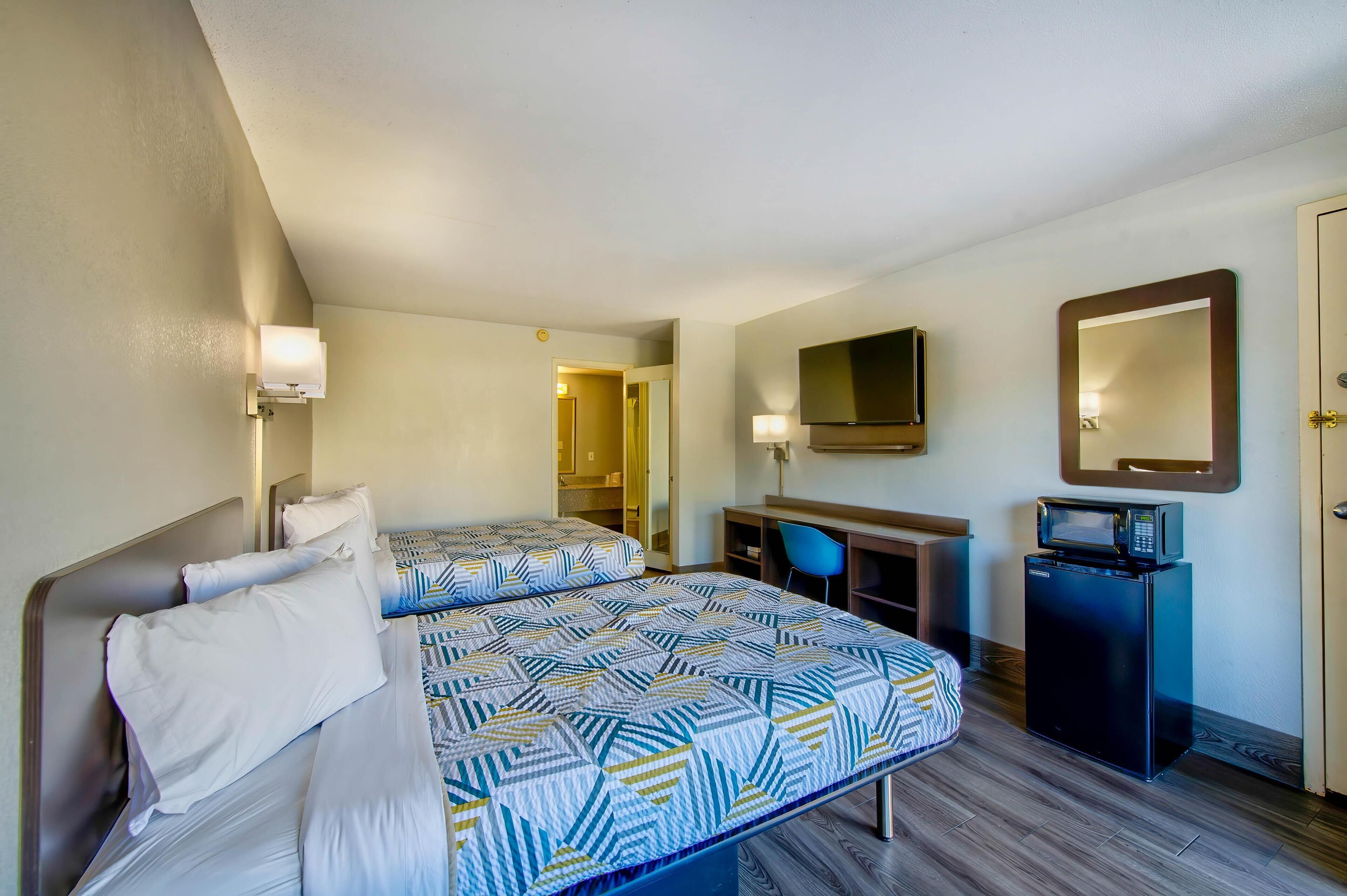 Premium bedding, desk, laptop workspace, rollaway beds