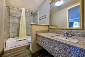 Combined shower/bathtub, towels, soap, toilet paper