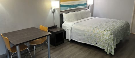 Premium bedding, desk, laptop workspace, blackout drapes