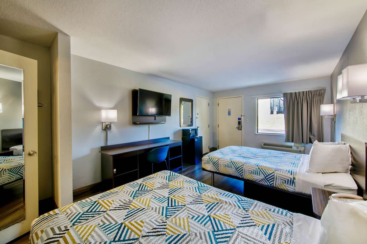 Premium bedding, desk, laptop workspace, rollaway beds