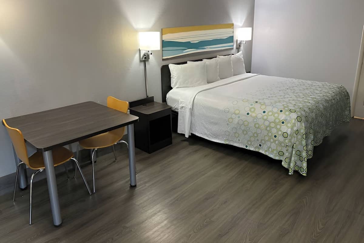 Premium bedding, desk, laptop workspace, blackout drapes