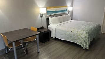 Premium bedding, desk, laptop workspace, blackout drapes