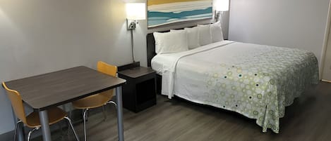 Premium bedding, desk, laptop workspace, blackout drapes
