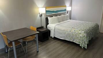 Premium bedding, desk, laptop workspace, blackout drapes
