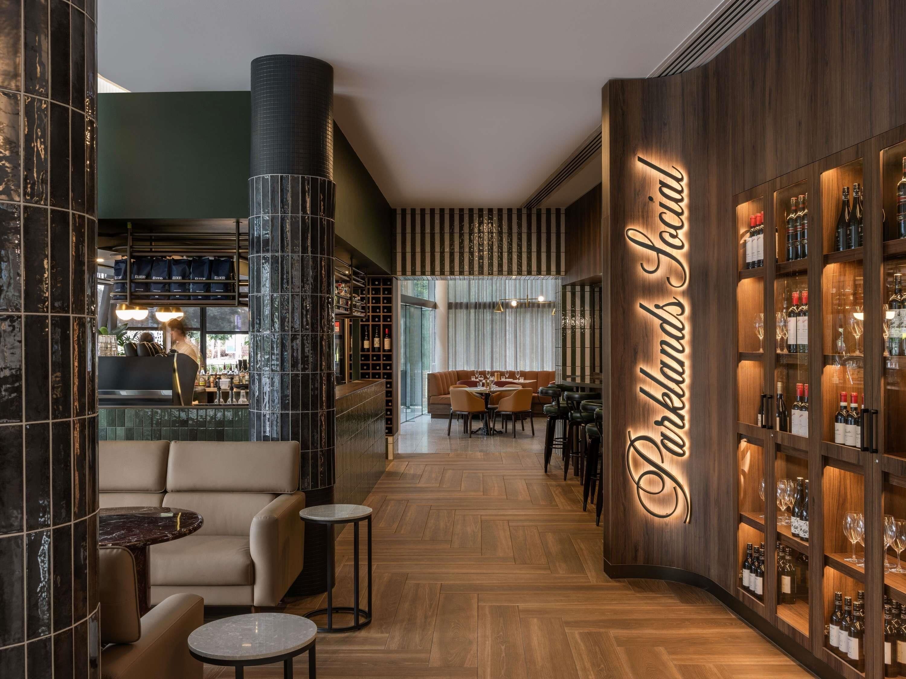 A bar area with a wine rack and seating.