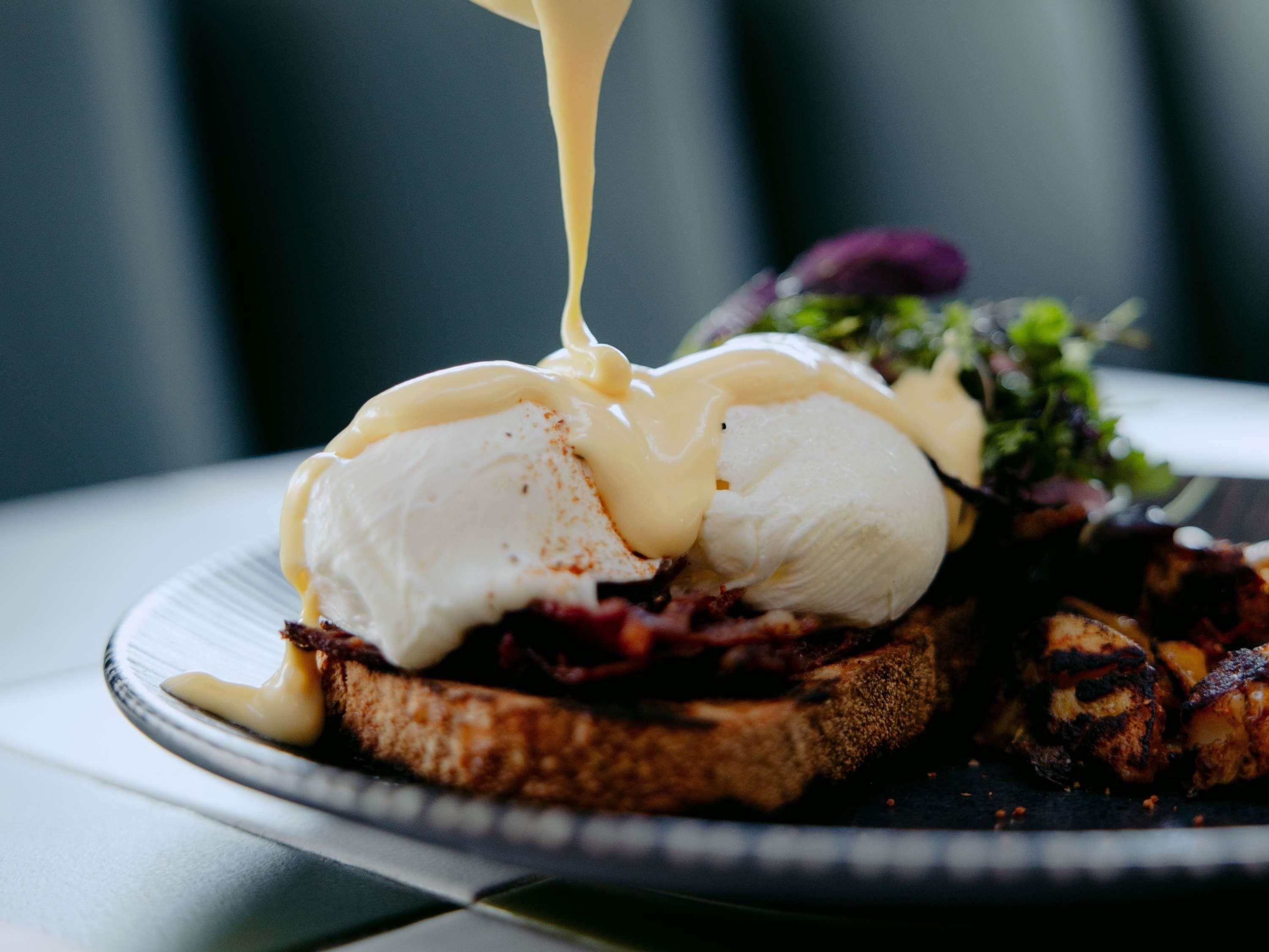 A plate with a poached egg, toast, and a side salad.