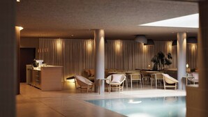 A modern indoor pool area with a reception desk, seating, and a large window. - Hagastrand, Autograph Collection (Solna)