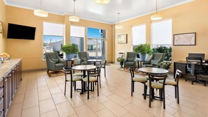 A spacious room with multiple seating areas, large windows, and ceiling lights. - Best Western Paradise Inn Of Nephi (Nephi)