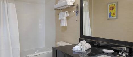 Un baño moderno con ducha, inodoro y lavamanos.