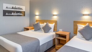 A hotel room with two beds, a cityscape artwork on the wall, and two wall-mounted lights. - Britannia Hotel Manchester Airport (Manchester)