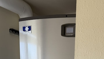 A stainless steel water dispenser with a digital display and a hand sanitizer dispenser.