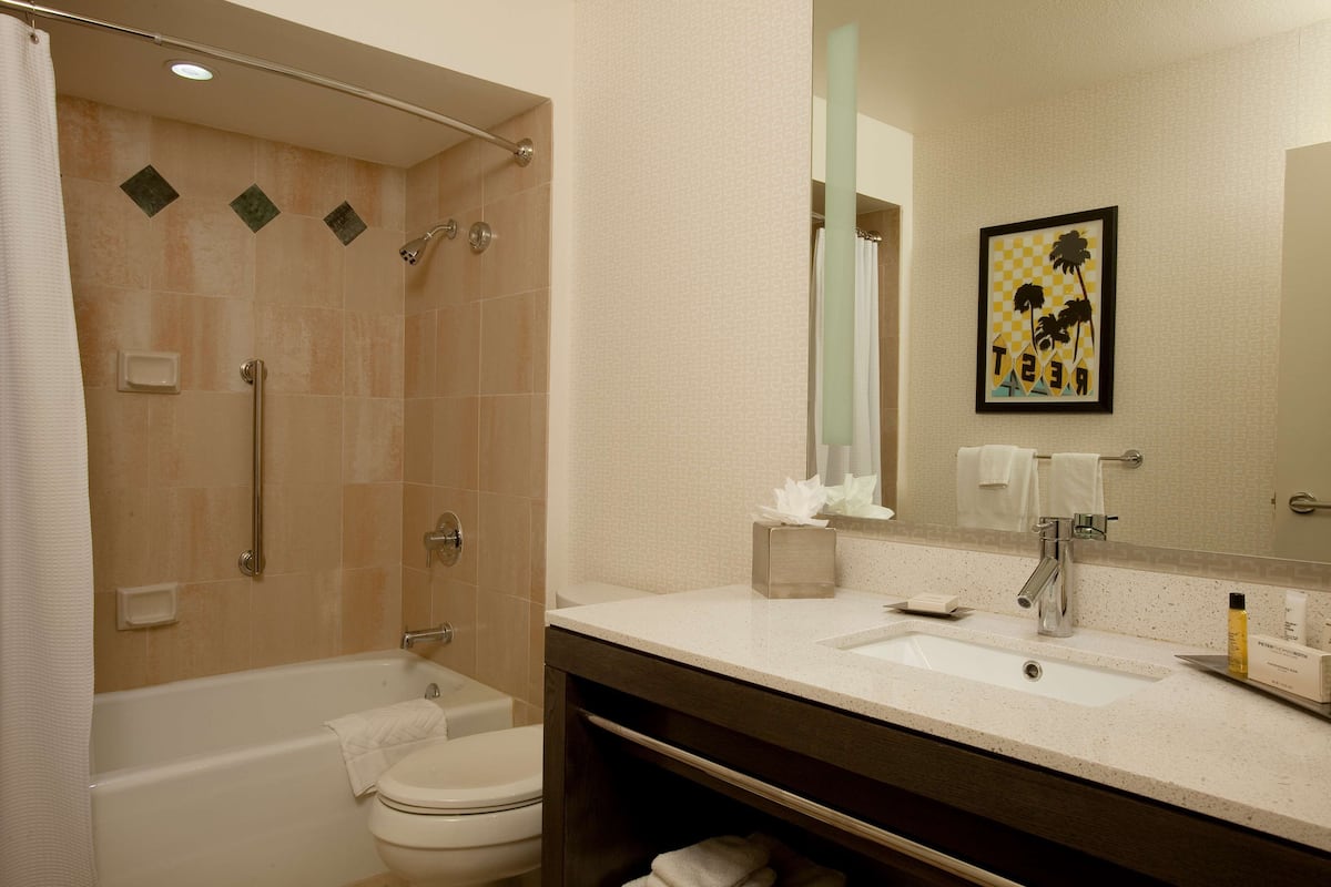 combined shower/bathtub, designer toiletries, hair dryer, bathrobes